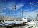 A section of the vast HAARP antenna field, looking down a row of transmitter shelters.